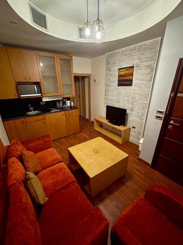 a living room with a red couch and a table at sea view house in Marsa Alam City