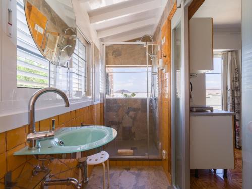 a bathroom with a glass sink and a shower at Casa Las Tuneras, Solo Adultos in La Oliva