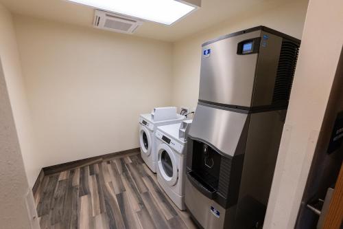 a laundry room with a washer and dryer at Cobblestone Hotel & Suites-Sheldon in Sheldon