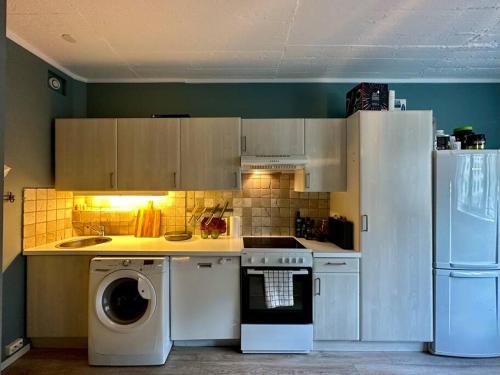 a kitchen with a washing machine and a refrigerator at Great apartment centrally located on Majorstua in Oslo