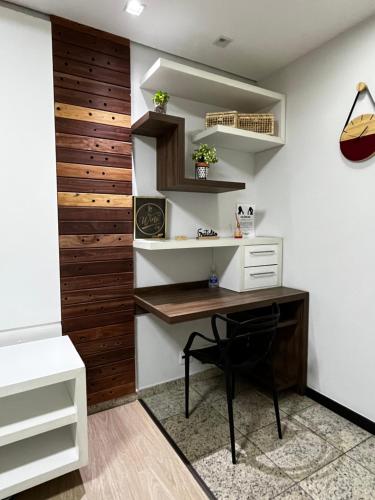 a home office with a desk and shelves at Apart Hotel Seg Total Lofts Encantadores in Mogi-Guaçu