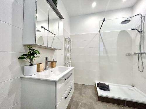 a white bathroom with a sink and a shower at Modern Stylish Studio near Center in Vienna