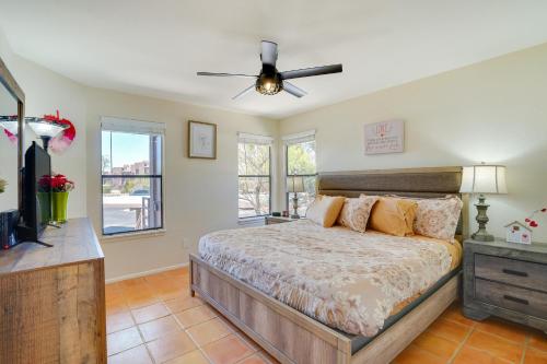 a bedroom with a bed and a ceiling fan at Tucson Oasis Heated Pool, Tennis Court, Hiking! in Tucson