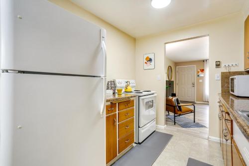 a kitchen with a white refrigerator and a stove at Scandi Boho Seattle Apartment, Walk to Waterfront! in Seattle