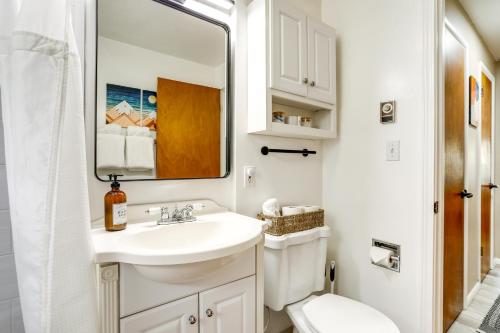 a bathroom with a sink and a toilet and a mirror at Scandi Boho Seattle Apartment with a King-Sized Bed in Seattle