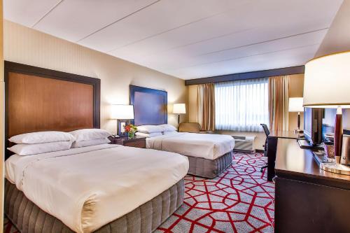 a hotel room with two beds and a television at DoubleTree by Hilton Chicago/Alsip in Alsip
