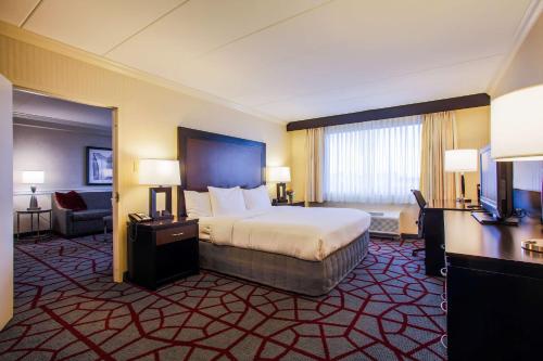 a large hotel room with a bed and a desk at DoubleTree by Hilton Chicago/Alsip in Alsip