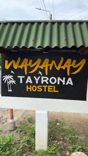 a sign for a hawaiian tavernanna hospital at WAYANAY TAYRONA ECO HOSTEL in El Zaino