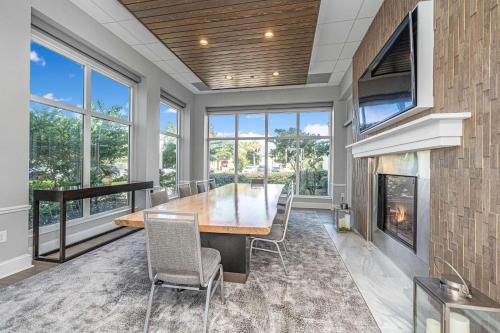 a dining room with a table and a fireplace at Hilton Garden Inn Charleston Airport in Charleston