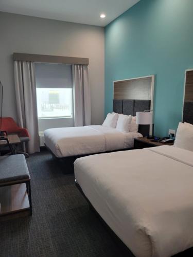 a hotel room with two beds and a window at Comfort Inn Miramar Beach-Destin in Destin