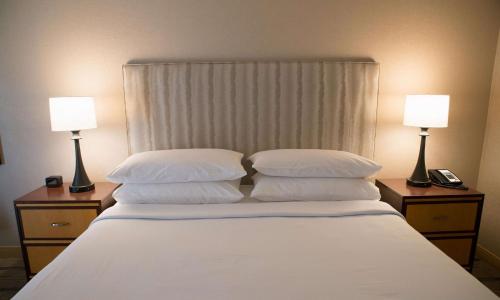 a bedroom with a bed with two lamps on night stands at Hilton Wilmington/Christiana in Newark