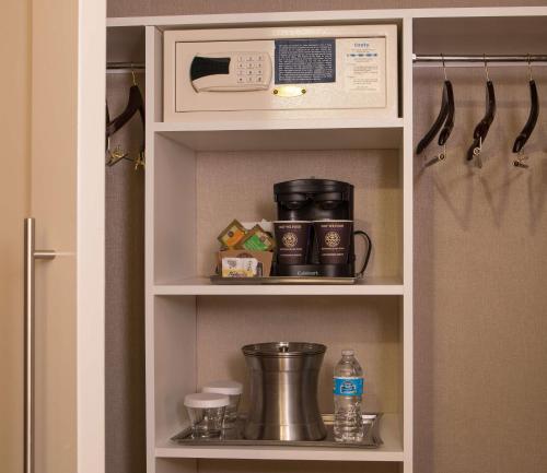 a kitchen pantry with a cupboard with a microwave at Hilton Wilmington/Christiana in Newark