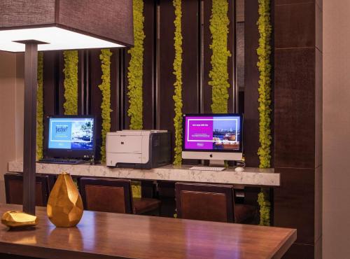 a dining room with two televisions and a table at Hilton Wilmington/Christiana in Newark