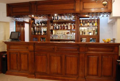 a large wooden bar with alcohol bottles at Hotel Gallant Sibiu in Sibiu