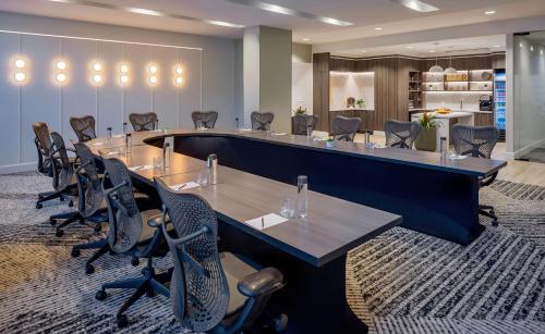 a conference room with a long table and chairs at Hilton Richmond Downtown in Richmond
