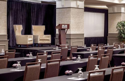 a conference room with tables and chairs and a podium at Hilton Richmond Downtown in Richmond