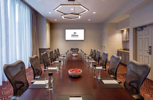 a long conference room with a long table and chairs at Hilton Richmond Downtown in Richmond