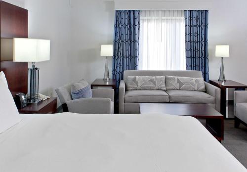 a hotel room with a bed and a couch at Hilton Scranton & Conference Center in Scranton