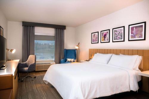 a hotel room with a large bed and a window at Hilton Garden Inn Sudbury, Ontario, Canada in Sudbury