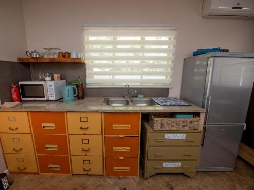 a kitchen with a sink and a refrigerator at Die Moerbeiboom in Bloemfontein