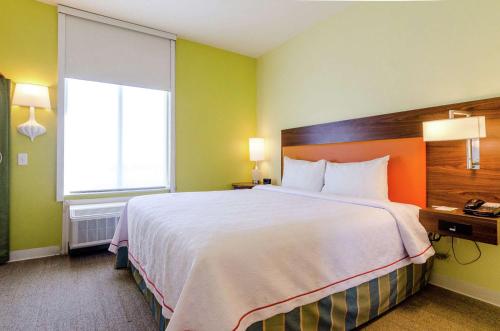 a hotel room with a large bed and a window at Home2 Suites by Hilton Portland in Portland