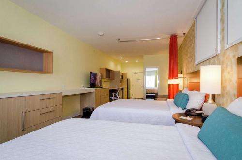 a hotel room with two beds and a television at Home2 Suites by Hilton Portland in Portland