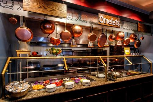 a kitchen with pots and pans and food at Hilton Garden Inn New York/Staten Island in Staten Island