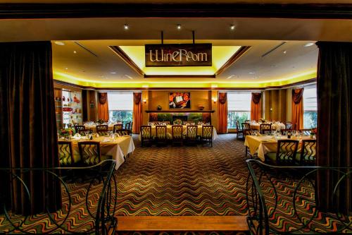 a dining room with tables and a sign that reads lunch point at Hilton Garden Inn New York/Staten Island in Staten Island