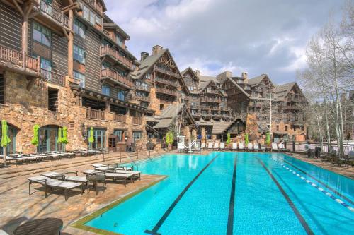 a large swimming pool in front of a building at Bachelor Gulch Village in Avon