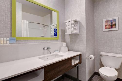 a bathroom with a sink and a toilet and a mirror at Hampton Inn & Suites Canal Winchester Columbus in Canal Winchester