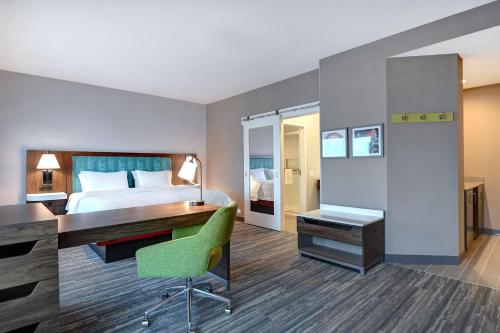 a hotel room with a bed and a desk at Hampton Inn & Suites Canal Winchester Columbus in Canal Winchester