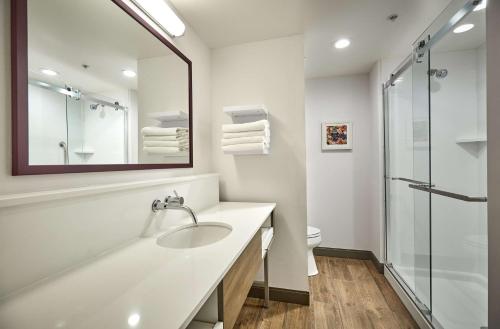 a white bathroom with a sink and a shower at Hampton Inn & Suites Roseburg in Roseburg