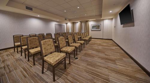 a conference room with chairs and a flat screen tv at Hampton Inn & Suites Roseburg in Roseburg
