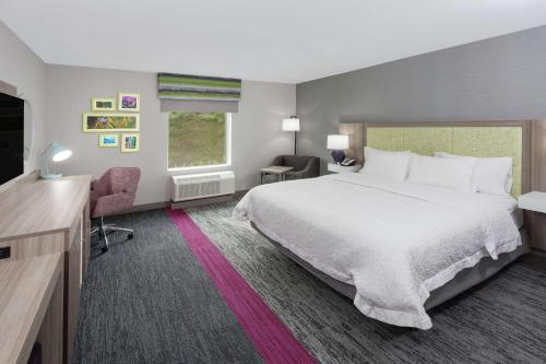 a hotel room with a large bed and a television at Hampton Inn & Suites Rocky Hill - Hartford South in Rocky Hill