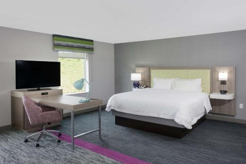 a bedroom with a bed and a desk and a tv at Hampton Inn & Suites Rocky Hill - Hartford South in Rocky Hill