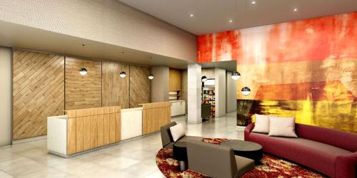 a lobby of a hotel with a couch and chairs at Homewood Suites By Hilton Belmont in Belmont