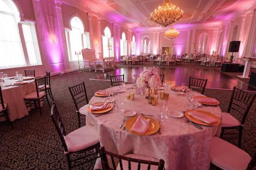 a banquet hall with tables and chairs with purple lighting at Berkeley Oceanfront Hotel in Asbury Park