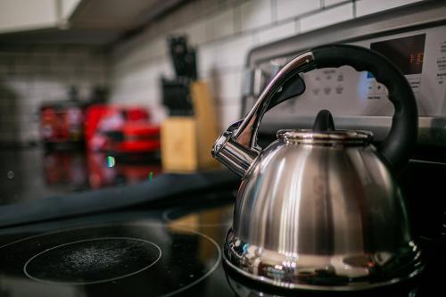 a tea kettle sitting on top of a stove at Thematic House with Private PoolSpaGame Room in Loughman
