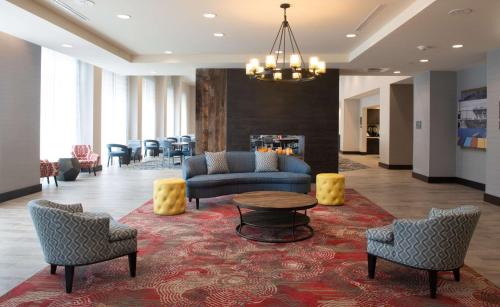a lobby with a couch and chairs and a table at Homewood Suites By Hilton North Charleston in Charleston