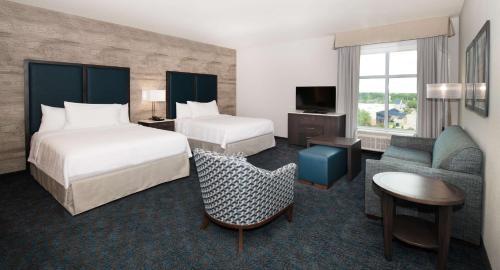 a hotel room with two beds and a television at Homewood Suites By Hilton North Charleston in Charleston