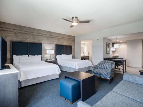a hotel room with two beds and a living room at Homewood Suites By Hilton North Charleston in Charleston