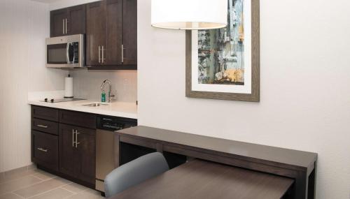 a kitchen with a counter and a table in a room at Homewood Suites By Hilton North Charleston in Charleston