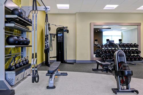 a gym with lots of exercise equipment and weights at Hilton Garden Inn Cedar Rapids in Cedar Rapids