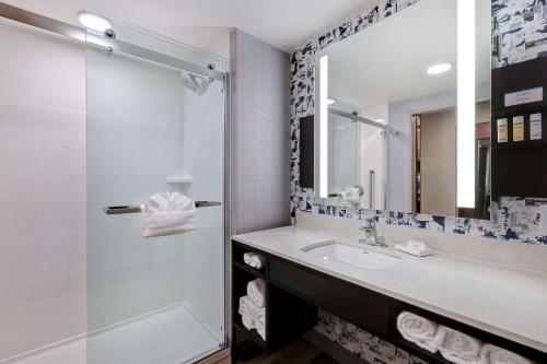 a bathroom with a sink and a shower at Hilton Garden Inn Cedar Rapids in Cedar Rapids