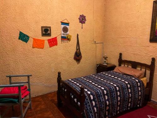 a bedroom with a bed and flags on the wall at El Patio de la Morocha in Montevideo
