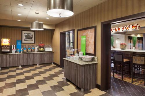 a lobby of a restaurant with a hair salon at Hampton Inn Pell City in Pell City