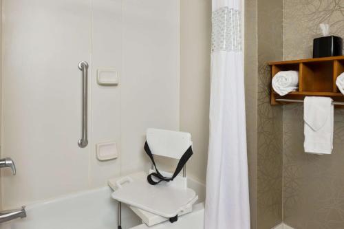 a bathroom with a shower and a toilet and a sink at Hampton Inn Pell City in Pell City