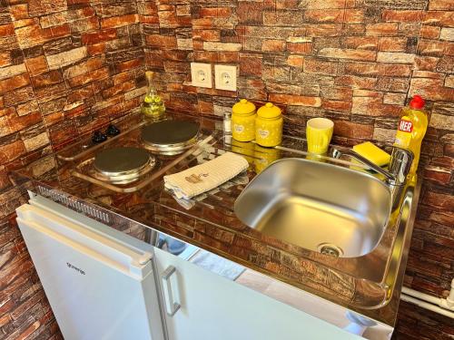 a kitchen with a sink and a counter top at Bungalows Fairy tale in Žabljak