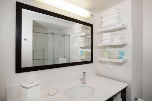 a white bathroom with a sink and a mirror at Hampton Inn St. Louis/Collinsville in Collinsville