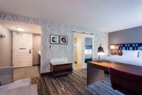 a hotel room with a bed and a desk at Hampton Inn & Suites Herndon-Reston in Herndon